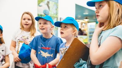A group of young pupils stood in a line looking ahead
